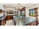 Spacious kitchen boasts a large island with stone countertops and stainless steel appliances at 5366 N Lake Farms Rd, De Leon Springs, FL 32130
