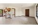 Open living room features tile flooring and is adjacent to the kitchen with natural wood cabinets at 5366 N Lake Farms Rd, De Leon Springs, FL 32130