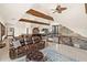 Spacious living room with wooden beams, leather sofa, bar, and staircase at 5366 N Lake Farms Rd, De Leon Springs, FL 32130