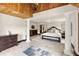 Bright and airy main bedroom with tile floors, columns, and an elegant bed set, creating a serene retreat at 5366 N Lake Farms Rd, De Leon Springs, FL 32130