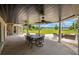 Covered patio with a large dining table and ceiling fans, ideal for enjoying meals outdoors at 5366 N Lake Farms Rd, De Leon Springs, FL 32130