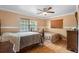 Bedroom featuring two beds, ceiling fan, large window and parquet floors at 558 Tulane Dr, Altamonte Springs, FL 32714