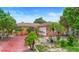 Single-story home featuring a red, paved driveway and tropical landscaping at 558 Tulane Dr, Altamonte Springs, FL 32714