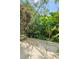A lush backyard oasis with verdant plants and custom hardscape offers a tranquil retreat at 5635 Burts Park Rd, De Leon Springs, FL 32130