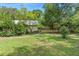 Beautiful backyard with lush green grass and mature trees, creating a serene and private outdoor space at 5635 Burts Park Rd, De Leon Springs, FL 32130