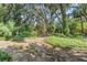 Lush greenery and mature trees creating a peaceful and serene backyard setting at 5635 Burts Park Rd, De Leon Springs, FL 32130