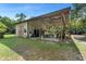 Spacious barn with a boat, covered parking, and outdoor workshop provides ample space for hobbies and projects at 5635 Burts Park Rd, De Leon Springs, FL 32130