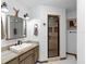 Bathroom featuring a modern vanity, stylish lighting, and walk-in glass shower at 5635 Burts Park Rd, De Leon Springs, FL 32130