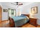 Comfortable bedroom features a ceiling fan, a window with natural light, and ample closet space at 5635 Burts Park Rd, De Leon Springs, FL 32130