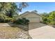 Charming single-story home featuring a two-car garage and lush landscaping at 5635 Burts Park Rd, De Leon Springs, FL 32130