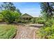 Charming home with a metal roof surrounded by lush greenery and a landscaped yard at 5635 Burts Park Rd, De Leon Springs, FL 32130