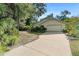 Charming single-story home featuring a two-car garage and lush landscaping at 5635 Burts Park Rd, De Leon Springs, FL 32130
