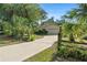 Charming single-story home with a well-manicured lawn, mature trees, and a long driveway at 5635 Burts Park Rd, De Leon Springs, FL 32130