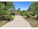 Charming single-story home with lush tropical landscaping and a long driveway at 5635 Burts Park Rd, De Leon Springs, FL 32130