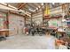 Spacious garage workshop featuring an array of tools, workbenches and ample storage shelves at 5635 Burts Park Rd, De Leon Springs, FL 32130