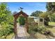 View of backyard showing garden shed and arbor at 5635 Burts Park Rd, De Leon Springs, FL 32130