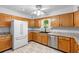 Bright kitchen with white tile floor, new fridge and plenty of storage at 5635 Burts Park Rd, De Leon Springs, FL 32130