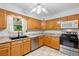 Bright kitchen with updated countertops, stainless steel appliances, and ample cabinet space at 5635 Burts Park Rd, De Leon Springs, FL 32130