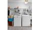 Laundry room with new washer and dryer, shelving and closet space for cleaning supplies at 5635 Burts Park Rd, De Leon Springs, FL 32130