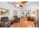 Living room leading to dining area, featuring hardwood floors and comfortable seating at 5635 Burts Park Rd, De Leon Springs, FL 32130