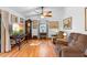Cozy living room featuring hardwood floors, ceiling fan, and comfortable seating for relaxation at 5635 Burts Park Rd, De Leon Springs, FL 32130