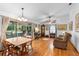 Bright living room featuring hardwood floors, a ceiling fan, and a screened-in patio at 5635 Burts Park Rd, De Leon Springs, FL 32130