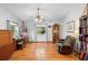 Well-lit living room with hardwood floors, a fan, and comfortable furniture at 5635 Burts Park Rd, De Leon Springs, FL 32130