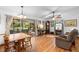 Spacious living room with hardwood floors, a ceiling fan, and access to a screened-in patio at 5635 Burts Park Rd, De Leon Springs, FL 32130