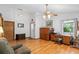 Inviting living room with beautiful wood floors and white walls at 5635 Burts Park Rd, De Leon Springs, FL 32130