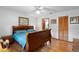 Bedroom with hardwood floors, natural light, closet, and access to ensuite bathroom at 5635 Burts Park Rd, De Leon Springs, FL 32130