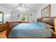 Serene bedroom featuring a comfortable bed, window, and ample natural light at 5635 Burts Park Rd, De Leon Springs, FL 32130