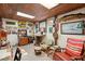 Cozy home office with wood paneling, comfortable seating, and decorative nautical accents at 5635 Burts Park Rd, De Leon Springs, FL 32130