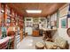 Inviting home office featuring wood ceiling, vintage decorations and built-in shelving at 5635 Burts Park Rd, De Leon Springs, FL 32130