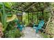 Secluded patio featuring a trellis roof, outdoor seating, and lush greenery offers a private escape at 5635 Burts Park Rd, De Leon Springs, FL 32130