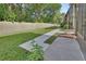 A backyard with a concrete walkway along the side of the home, leading to a grassy area at 600 N Boundary Ave # 118B, Deland, FL 32720