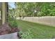 A long and well-maintained lawn in the backyard, bordered by a wooden fence and lush trees at 600 N Boundary Ave # 118B, Deland, FL 32720