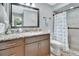Bathroom featuring a granite countertop vanity and tiled shower with tub at 600 N Boundary Ave # 118B, Deland, FL 32720