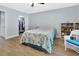 Bedroom featuring wood-look flooring, ceiling fan and walk-in closet at 600 N Boundary Ave # 118B, Deland, FL 32720