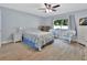 Bedroom with wood-look flooring, ceiling fan, and natural light from a large window at 600 N Boundary Ave # 118B, Deland, FL 32720
