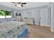 Bright bedroom with wood-look floors, ceiling fan and closet space at 600 N Boundary Ave # 118B, Deland, FL 32720