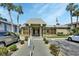 Community clubhouse featuring well-maintained landscaping, an American flag, and convenient parking at 600 N Boundary Ave # 118B, Deland, FL 32720