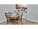 Cozy dining area with a wooden table, hardwood floors, and a view of the kitchen, perfect for Gathering meals at 600 N Boundary Ave # 118B, Deland, FL 32720