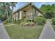 Charming condo building showcasing lush landscaping with mature trees and well-maintained green spaces, offering a serene atmosphere at 600 N Boundary Ave # 118B, Deland, FL 32720