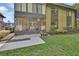 View of the condo's exterior, featuring a screened-in patio with potted plants at 600 N Boundary Ave # 118B, Deland, FL 32720