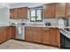 Well-equipped kitchen featuring stainless steel appliances, granite countertops, and ample storage space, perfect for cooking at 600 N Boundary Ave # 118B, Deland, FL 32720