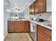 Bright kitchen with wood cabinets, granite countertops, and stainless steel dishwasher at 600 N Boundary Ave # 118B, Deland, FL 32720
