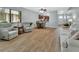 Open living room with hardwood floors, a dining area, and a view of the kitchen, ideal for entertaining guests at 600 N Boundary Ave # 118B, Deland, FL 32720