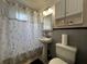 Bathroom featuring pedestal sink, toilet, and shower-tub combo at 601 Berkshire Rd, Daytona Beach, FL 32114
