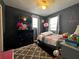 bedroom with dark painted walls, plush rug, and a ceiling fan at 601 Berkshire Rd, Daytona Beach, FL 32114