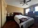 Bedroom with hardwood floors, large bed, and dual windows at 601 Berkshire Rd, Daytona Beach, FL 32114